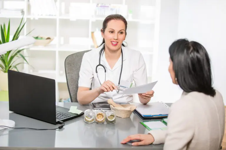 Young Doctor Having A Happy Conversation With The Patient