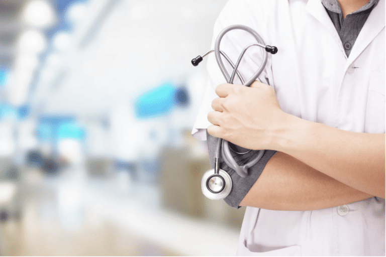 Doctor holding stethoscope in hospital setting