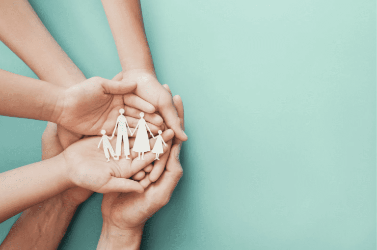 Hands holding medication and healthcare support items